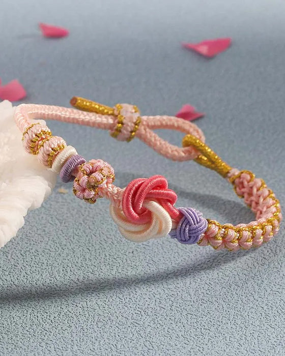 Armbånd med knute av ferskenblomster