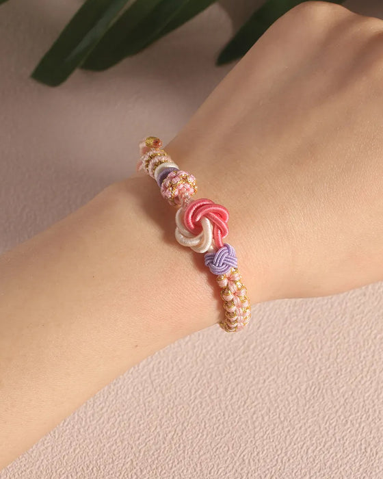 Armbånd med knute av ferskenblomster