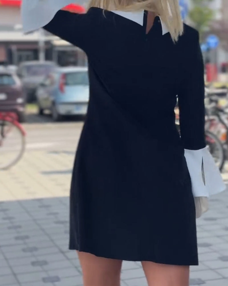 Elegant kjole med klokkeermer i kontrastfarge