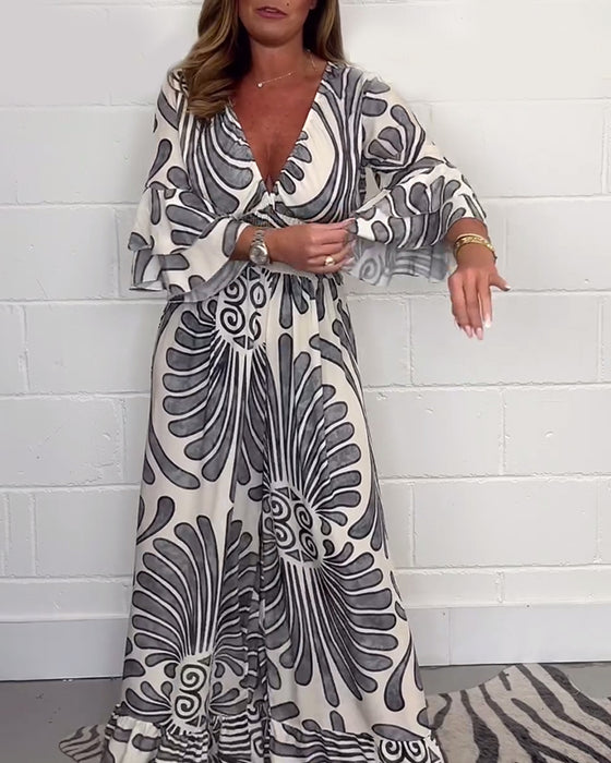 Deep V løs jumpsuit med retroprint og klokkeerm