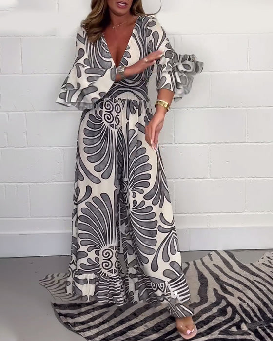 Deep V løs jumpsuit med retroprint og klokkeerm