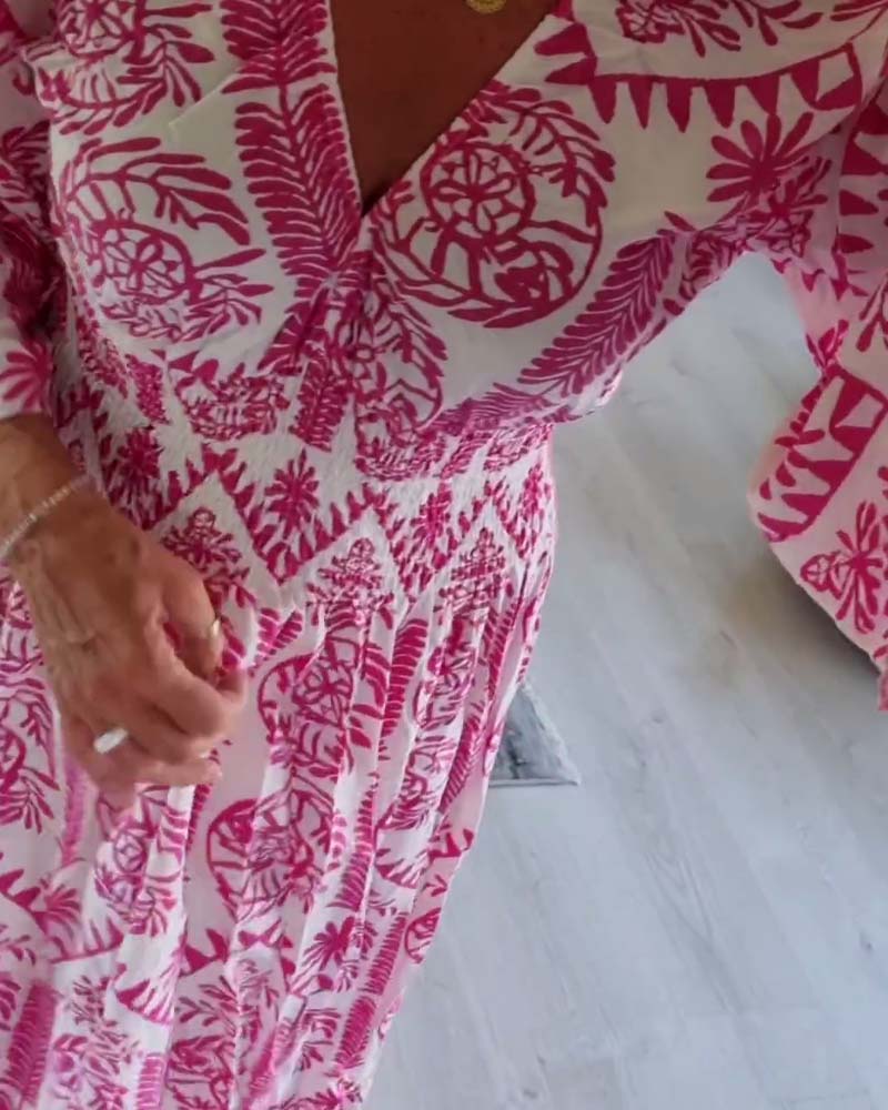 Elegant kjole med trykk med V-hals-fold og klokkeerm