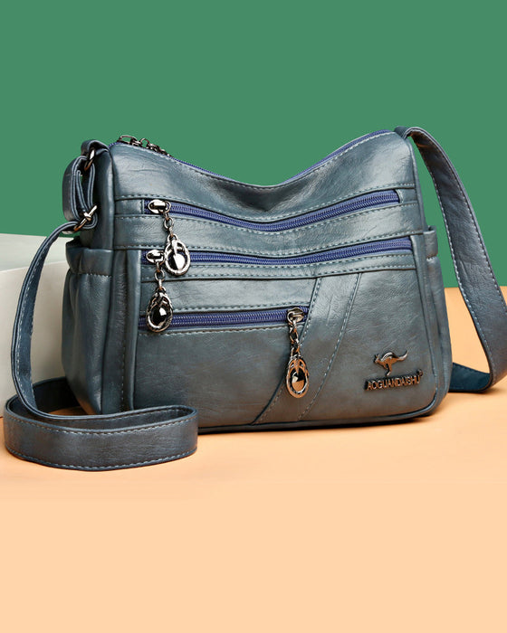 Crossbody-veske i mykt skinn med multilomme