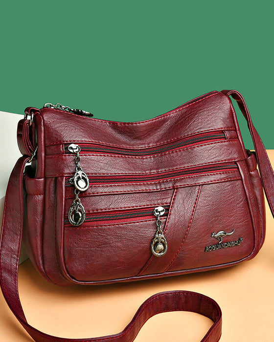 Crossbody-veske i mykt skinn med multilomme