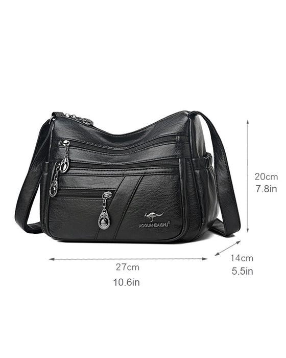 Crossbody-veske i mykt skinn med multilomme