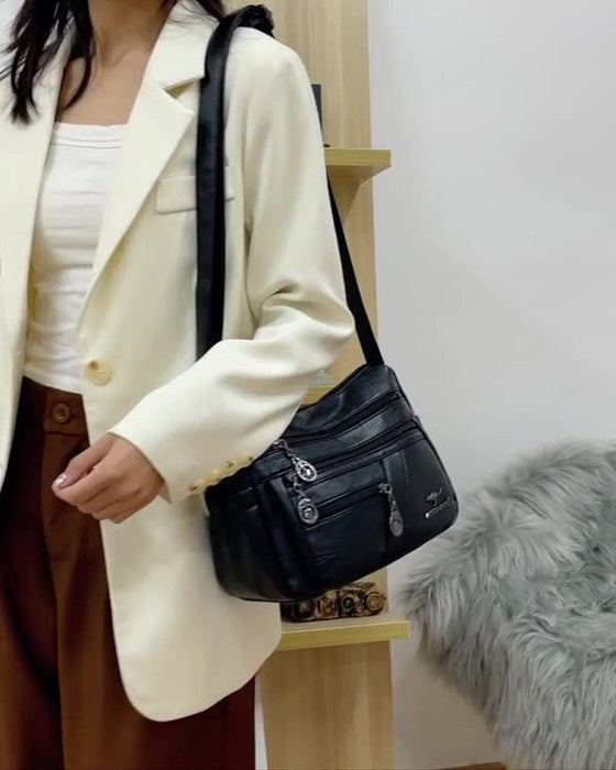 Crossbody-veske i mykt skinn med multilomme