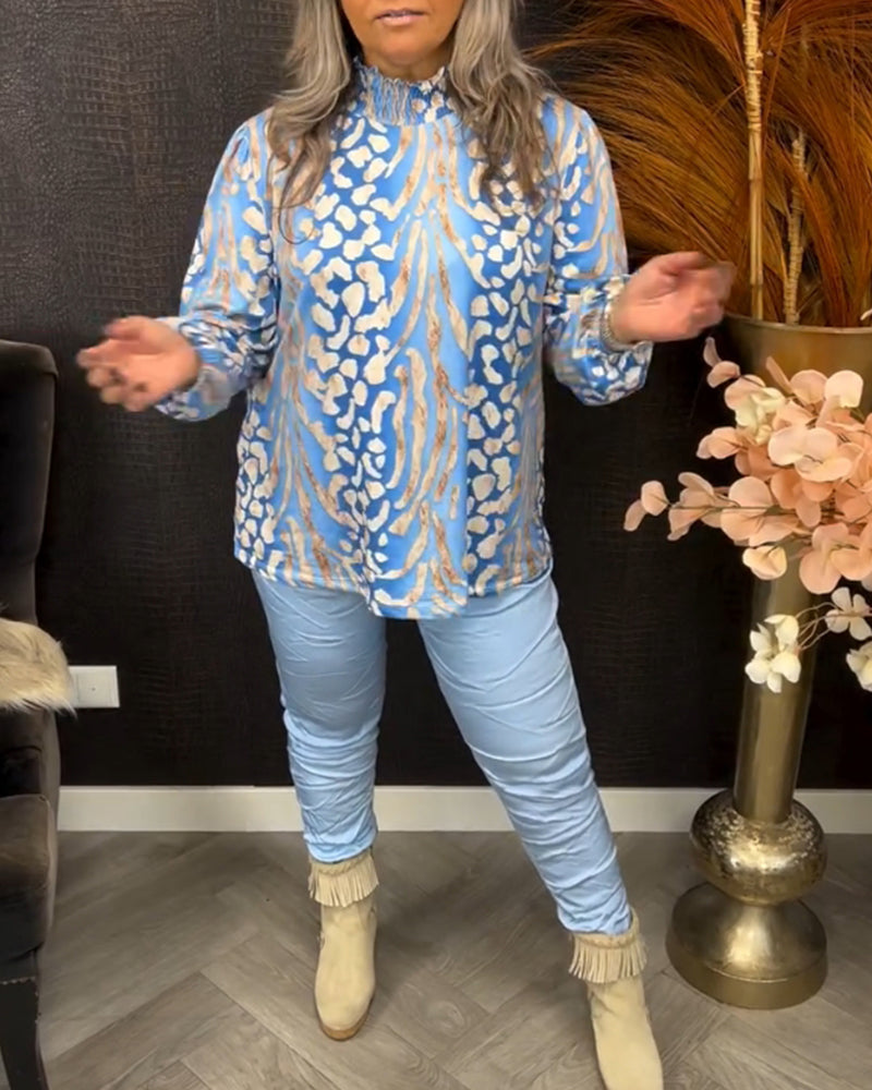 Topp med stativkrage og lange ermer og trykk