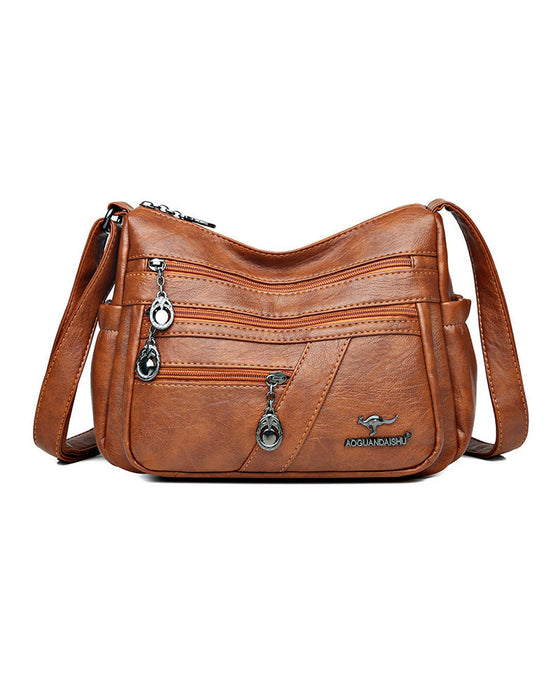 Crossbody-veske i mykt skinn med multilomme
